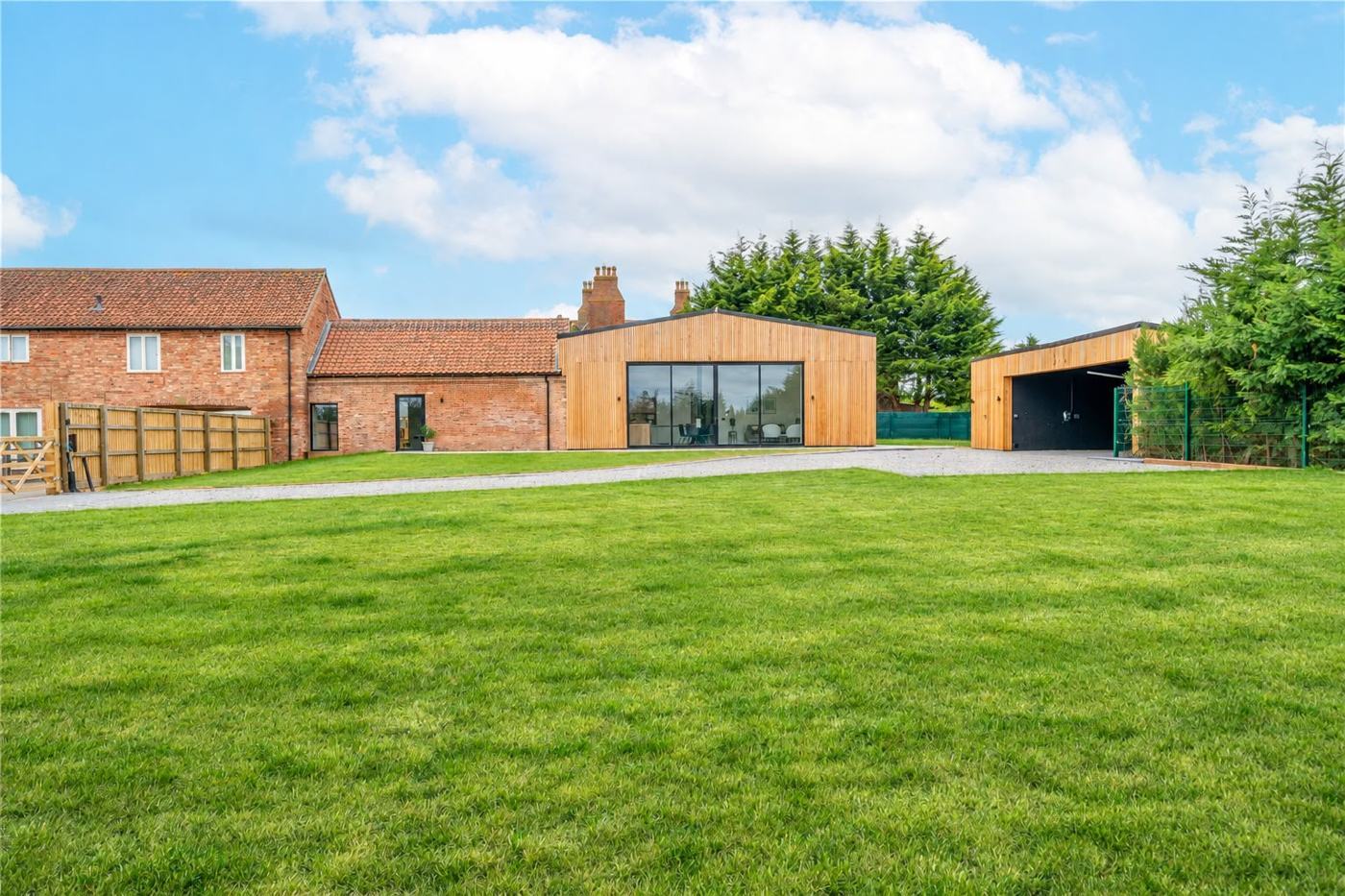 Brefnie Stables, a timber and brick barn conversion with a large lawn